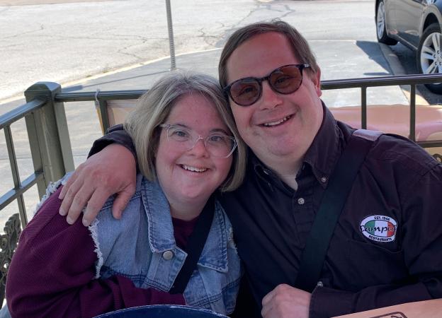 Man and woman with Down syndrome hugging