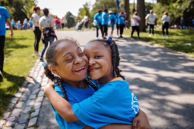 young girls with Down syndrome hugging