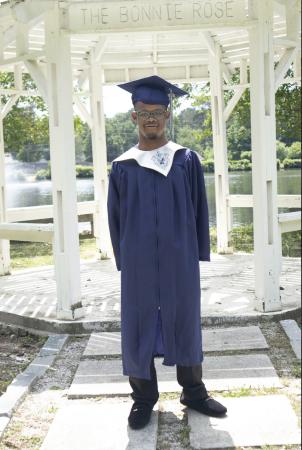 man with Down syndrome in his graduation cap and gown